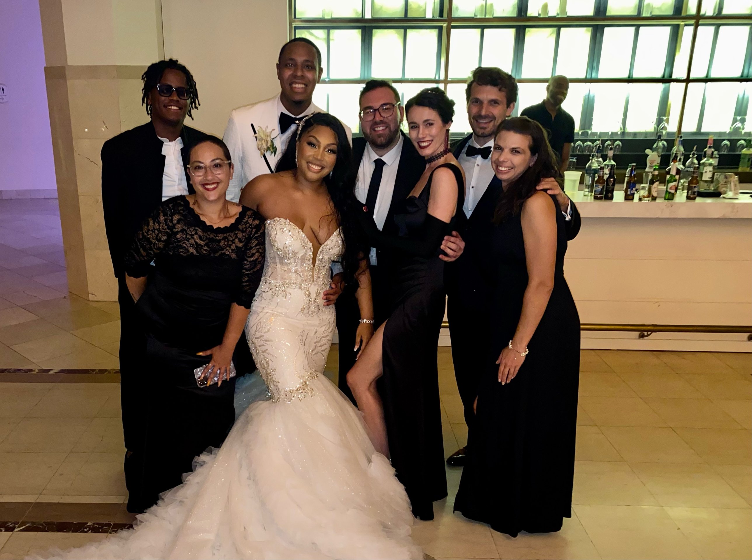 Gregory and Sherah with a large group of close friends at the wedding