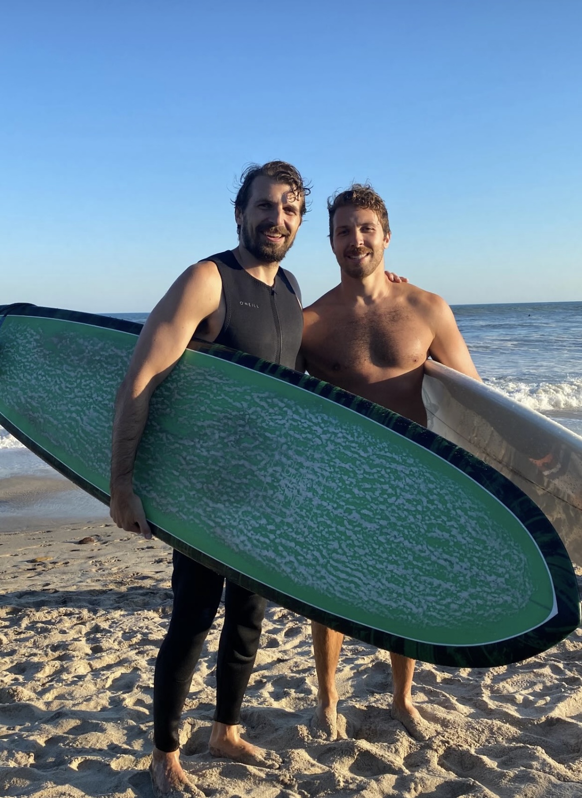 Gregory surfing with his brother